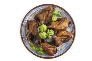 Smoked quails on a ceramic plate isolated on white background