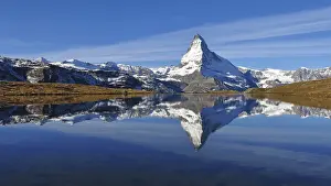 Snow capped Matterhorn mirroring in lake Stellisee