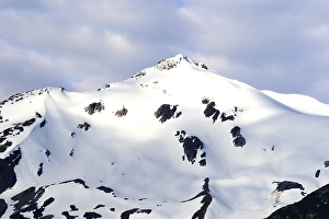 Snow capped mountains, A steel bridge constructed in 1901, tallest cantilever bridge in the world used until 1969, Skagway, Alaska, U.S.A. United States of America