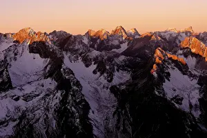 Snow-covered Alpine peaks at sunrise