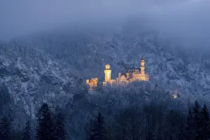 Snow-covered castle, illuminated at dusk