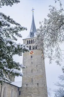 Snow-covered church tower with clock