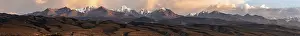 Snow-covered and glaciated mountain peaks at sunset