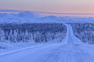 Snow-covered gravel road, highway