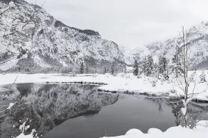Snow covered Lake Almsee which is partly frozen and snow covered