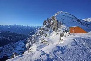 Snow-covered mountain landscape under a clear blue sky