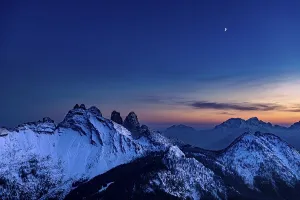 Snow-covered mountain peaks of the Bosconero group at blue hour