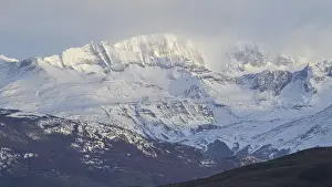 Framed Print : Snow-covered mountains under a cloudy sky Framed Print : Snow-covered mountains under a cloudy sky