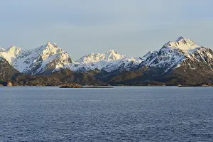 Snow-covered mountains on Hadselfjord in the evening light