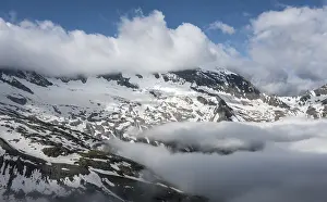 Snow-covered mountains, high alpine landscape with clouds