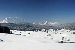 Snow-covered pastures and hay barns