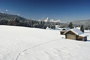 Snow-covered pastures and hay barns