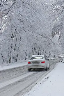 Snow-covered road in winter with traffic