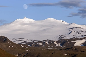Snow-covered Snaefell volcano with Snaefellsjoekul glacier and full moon