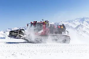 Snowcat on a slope high up in the mountains