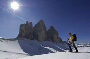 Snowshoe hiker passing the Drei Zinnen Mountain or Tre Cime di Lavaredo