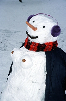 Snowwoman, snowman with ear protectors