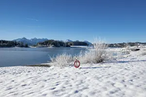 Snowy lake with a clear view of distant mountains
