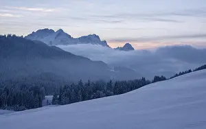 Snowy landscape with mountain view of the Wetterstein mountains and forest at sunset at Geroldsee (Mittenwald)