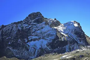 Snowy mountain peak under clear blue sky