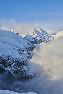 Snowy Mountains above the clouds at Hochalpenstrasse