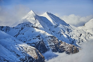 Snowy Mountains above the clouds at Hochalpenstrasse