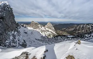 Snowy rocky ridge and view into the valley