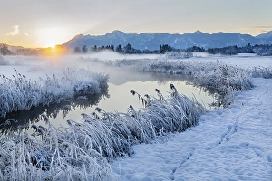 Snowy winter landscape with the Uffinger Ach at sunrise with Herzogstand 1731m and Heimgarten 1790m