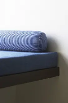 Sofa cum bed with long blue color round cushion