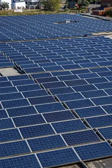 Solar panels are covering an industrial building rooftop