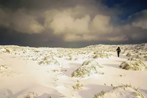 Solitary hiker ascending through the snow at Puig de Massanella