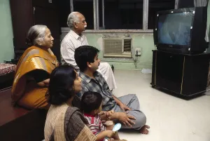 South asian indian family watching television