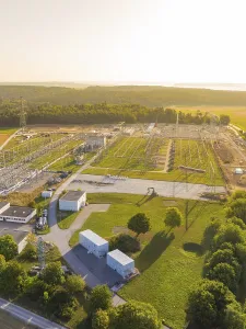 Spacious transformer station with extensive technology and power lines in a green environment