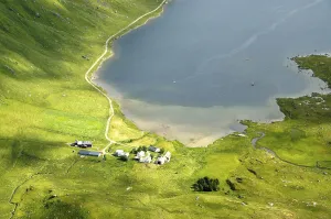 Spots of sun at mountains and lake Kartfjorden Vestvagoya Lofoten Norway