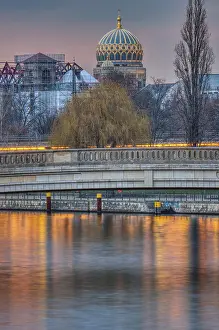 The Spree in Berlin at sunset with the dome of the New Synagogue in the background