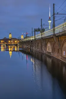 The Spree, the TV Tower and a moving train in Berlin at dusk