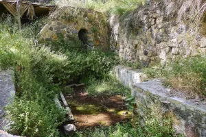 Spring, Poria spring, stone ruins overgrown with plants