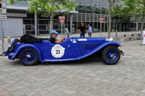 SS1, classic blue convertible at a stylish rally event with a driver