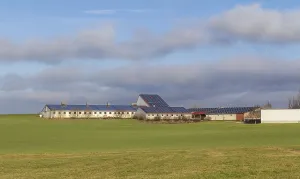 Stabling with solar panels surrounded by farmland in Southern Germany