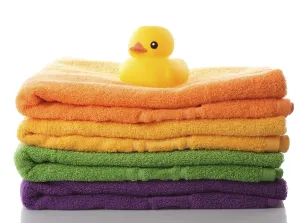 Stack of colorfull towels and yellow rubber duck isolated on white