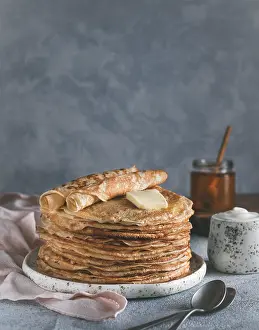 Stack of traditional russian pancakes blini on gray background with copy space