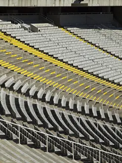 Empty stadium stands with yellow and grey seating pattern
