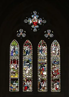 Stained glass window with religious depictions and bright colours