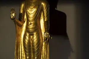Standing gilded Buddha statue, the right hand (raised)