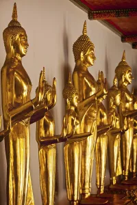Standing golden Buddha statues close up