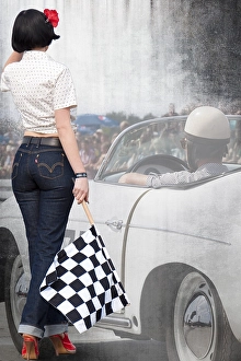 Starter girl standing next to a classic car