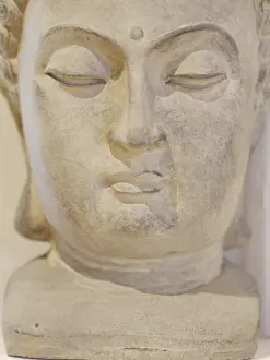 A statue of a face with a serene expression