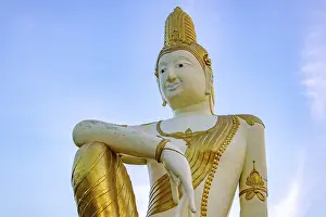 The statue of future Buddha Maitreya on blue background
