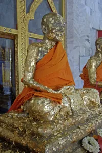 Statue of a monk covered with a golden plate