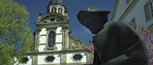 Statue of pilgrims in Speyer, behind the Trinity Church